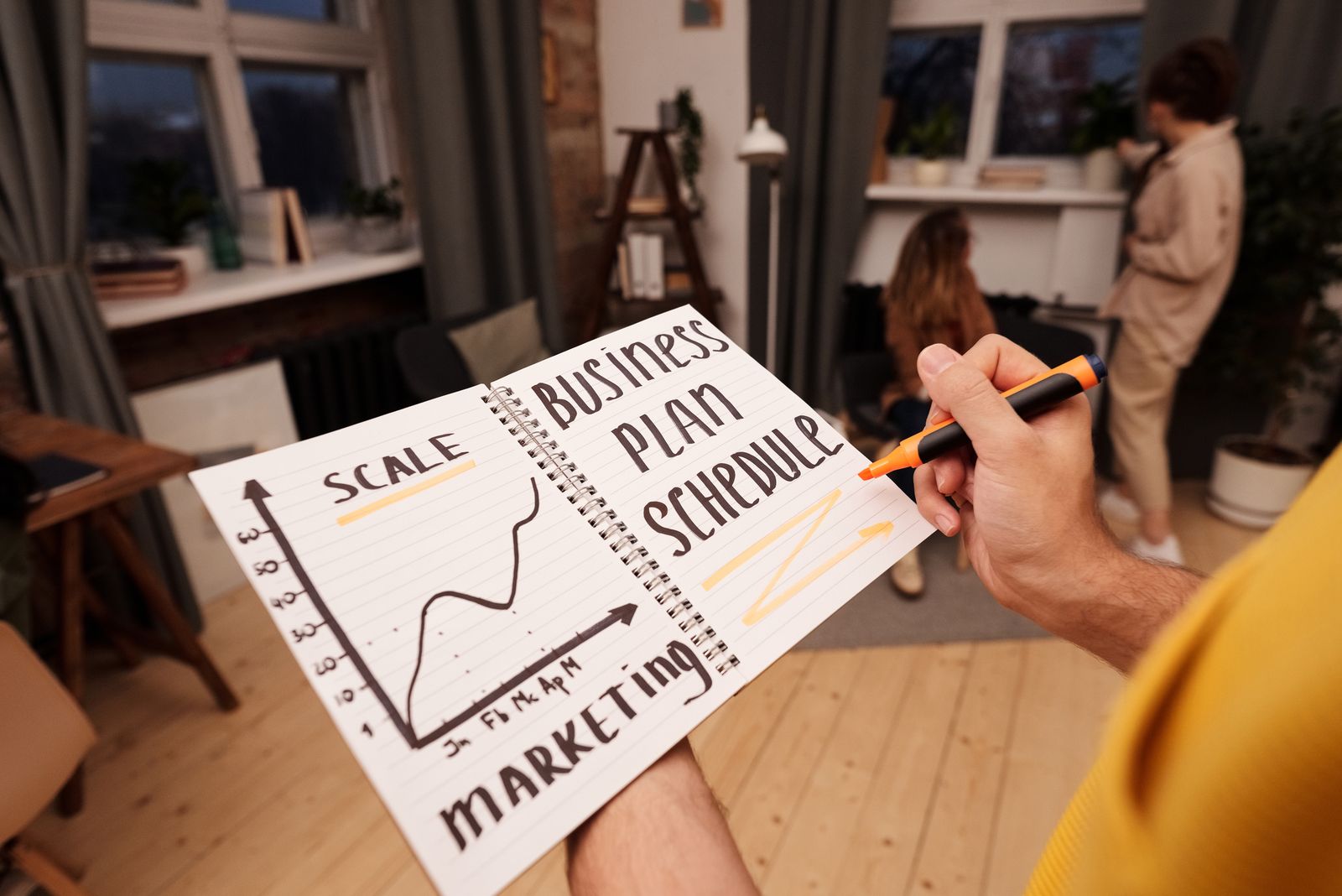 A professional reviews business graphs and planning notes, illustrating evidence-led brand and positioning decisions.